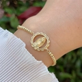 Close-up of 18K gold plated Our Lady of Guadalupe bracelet with cubic zirconia on wrist - Hollow Our Lady Of Guadalupe (1)