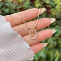 Macro detail of 18K gold plated necklace featuring a sparkling diamond letter K pendant - Gold K