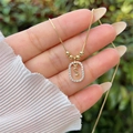 Macro shot of 18K gold plated S letter pendant with shimmering cubic zirconia inlay - Gold S