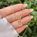 Detail of 18K gold plated letter U pendant necklace with sparkling zircon halo - Gold U
