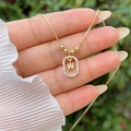 Detailed close-up of 18K gold plated letter W pendant with sparkling zircon accents - Gold W