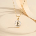 Detail of gold letter B pendant necklace with micro-paved cubic zirconia and elegant chain - Letter B