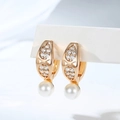 Detailed view of gold plated hoop earrings with zircon pavé and white round pearls - Hollow Pattern Style (EH865)