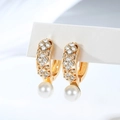Macro shot of gold-plated hoop earrings with sparkling cubic zirconia and white pearls - Symmetric Flower Pattern (EH866)