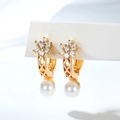 Detail of gold floral pearl earrings with cubic zirconia inlay and hollow diamond pattern - Hollow Rhombus Lattice Craft (EH867)