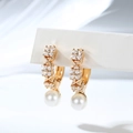 Macro detail of gold plated hoop earrings with zircon flowers and round pearl drop - Four-Petal Floral Design (EH868)