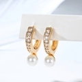 Macro shot of 18K gold plated hoop earrings with zircon pavé and a round white pearl - U-Shaped Metal Loop Design (EH876)
