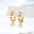 Macro detail of gold-plated hoop earrings with sparkling zircons and elegant white pearls - Hoop Pearl Pendant Style (EH879)