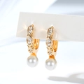 Close-up of vintage gold-plated hoop earrings featuring white pearls and zircon accents - Olive Outline Design (EH881)