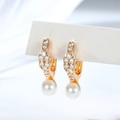 Macro detail of gold-plated pearl hoop earrings with shimmering cubic zirconia stones - Rhombic Pave Pearl Ear Buckle (EH883)