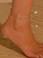 Close-up of gold double-layer anklet with snake and rope chain on beach sand - Gold (SE4030 Golden Yellow)