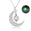 Detailed view of silver hollow moon pendant with a glowing green bead in the dark - Yellow-Green