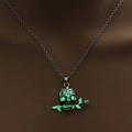 Gothic skull and rose necklace with green luminous glow on a dark display stand - Yellow-Green Luminous