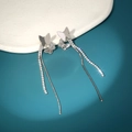 Detailed close-up of long tassel butterfly earrings with sparkling cubic zirconia on tray - Double Butterfly Tassel Style (NE1286)