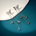 Macro detail of silver butterfly long tassel earrings with polished metallic surface finish - Five Butterfly Long Tassel Style (NE1291)