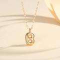 Detail of 18K gold-plated bubble letter B pendant on a delicate link chain necklace - Letter B