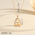 Macro view of bubble letter A pendant necklace with precise dimensions and shiny gold finish - Letter A