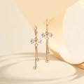 Close-up of gold-plated bow earrings with sparkling zircon and long box chain tassels - Gold White Zirconia