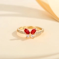 Macro view of butterfly ring featuring red marquise stones and gold pave zircon setting - US 7 / Gold Red Zirconia