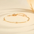 Minimalist gold-plated beaded chain bracelet with twisted metal links and adjustable clasp - Gold