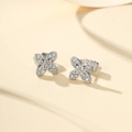 Macro detail of silver four-leaf clover earrings with sparkling pavé zircons - Silver