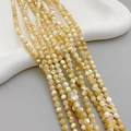 Polished natural yellow shell round bead strands with iridescent mother of pearl luster - 5mm Ball / Natural