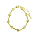 Detailed view of the lobster clasp, extension chain and heart charm on the golden bracelet - White