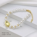 Detailed view of pearl bracelet featuring a gold bean pendant and adjustable lobster clasp - Gold Irregular Bead Pearl Bracelet (DN241215-D) / 18+5cm