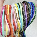 Close-up of colorful woven cords with striped patterns for DIY jewelry and crafts - Contact Support Link