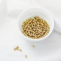 Polished 14K gold filled round beads for DIY jewelry making displayed in a white bowl - 14k Gold Filled