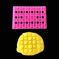 Pink rectangular plastic grid mold creating textured honeycomb patterns on yellow dough - Pink Circular Lattice