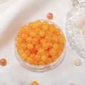 Orange translucent 8mm glass beads in a plastic storage box for DIY jewelry making - Yellow