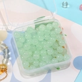 Pale green semi-transparent 8mm glass beads in a clear box with a golden sun charm bracelet - Light Green
