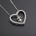 Silver hollow heart necklace with tiny zircon stones and a small girl pendant detail - Silver Heart with Girl (Platinum Plated)