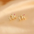 Detail view of 18k gold plated leaf earrings with multi-color zircon inlay on satin - Gold Plated Colorful Zircon Leaf