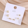 Ensemble de trois paires de boucles d'oreilles dorées avec zircons sur carte blanche - Géométrique (EO11-5)