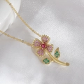 Exquisite gold floral necklace featuring pink zircons and a vibrant ruby-tone center stone - Necklace (With Chain) / Colorful