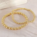 Zweiteiliges Set aus vergoldeten Perlenarmbändern mit glatter Metalloberfläche und Gummizug - 6+4mm Schneeflockenscheiben Armband Stapel