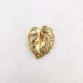 Golden monstera leaf pendant with hollow design and inlaid cubic zirconia crystals - Gold (NAD08-9)