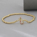 Detailed view of an 18k gold-plated beaded bracelet featuring a colorful gemstone pendant - Candy Cane Style (NAG09-5)