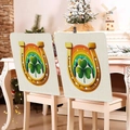 Detail of St. Patrick's Day chair covers with clover and horseshoe prints on linen fabric - Gold Horseshoe and Rainbow Style