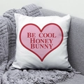 Detail of white peach skin pillow with 'BE COOL HONEY BUNNY' print on a grey sofa - 45x45 / Be Cool Honey Bunny Heart Design (DRD291-9)