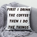 Detail of white square peach skin pillow with coffee quote resting on a grey sofa - 45x45 / First Drink Coffee Simple B&W Design (DRD291-14)