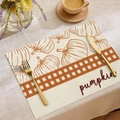 Dettaglio di tovaglietta in lino con stampe di zucca e motivo scozzese autunnale decorativo - Stile Nastro Quadri Zucca (CDZ05-31)