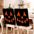 Detail of Halloween chair covers with orange pumpkin faces on black fabric for dining decor - Black Base Orange Pumpkin Face Style (YT56-30) / 1 Piece/Pack (49x58cm)