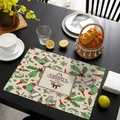Christmas place mat with Merry Christmas print and festive patterns on a black table - Linen