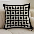 Close-up detail of luxury French cream style checkerboard pillow on a beige sofa - 45cmx45cm
