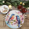 Close-up of a round floral placemat with bluebirds and cherry blossoms on a wooden table - Bluebirds And Pink Flowers (YCD01-13)