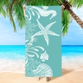 Microfiber beach towel in turquoise with white sea life prints on a sunny shore - Marine Life Design (STMJ03-3)