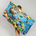Microfiber beach towel with sea turtle coral reef print held by model against grey background - Underwater World Tropical Fish Turtle (STMJ01-16)